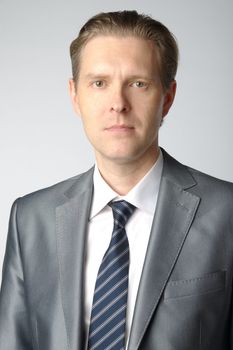 portrait of middle age businessman in austere suit