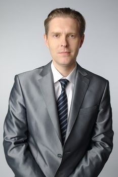 portrait of middle age businessman in austere suit