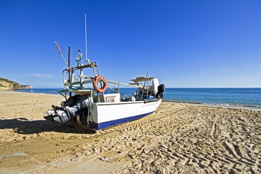 Fishing boat at the beach at Salema in Portugal
