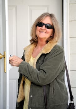Mature female beauty leaving home to go to work.