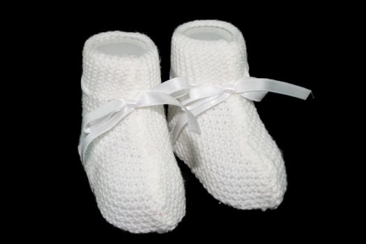 white baby socks with horizontal ties with black background