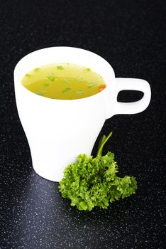 Broth in cup on table