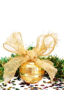 Gold Christmas bauble and green tinsel isolated on white background with copy space. 