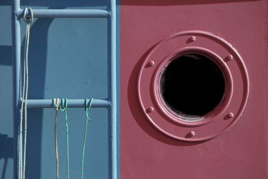 A window and stairs of an old fish ship