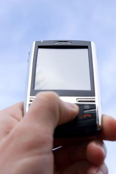 a hand holding a mobile phone for support             
