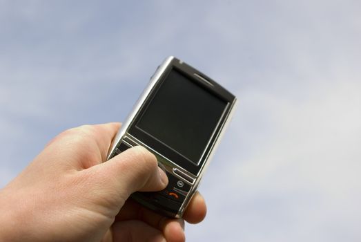a hand holding a mobile phone for support             