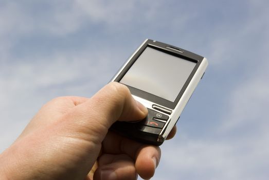 a hand holding a mobile phone for support             