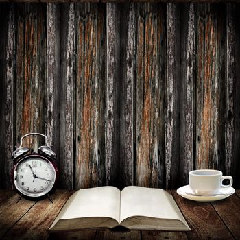 Time to read concept, Alarm clock beside open book with coffee cup