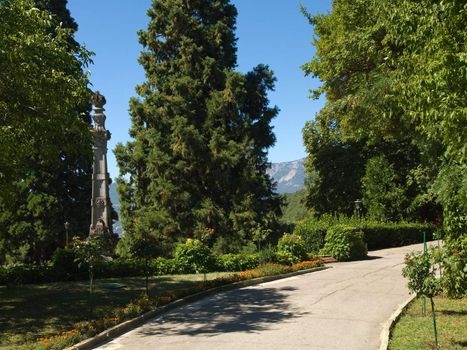 Path in subtropical park with column near Massandra Palace in Crimea