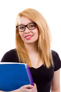 Stylish young college student holds her textbooks and smiles wearing glasses.