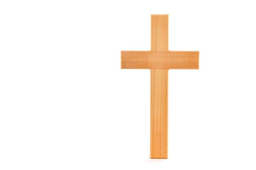 Wooden cross with grain standing on a white background.