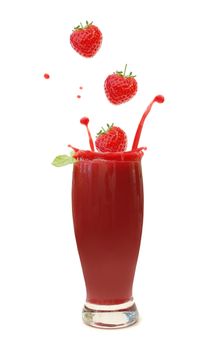 Strawberries splashing into a blended smoothie drink 