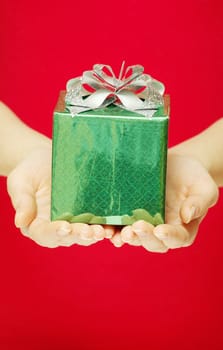 christmas gift in hands isolated on red 