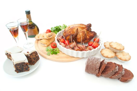 Traditional christmas spread including mince pies and bacon wrapped sausages 