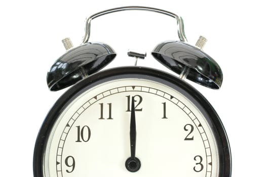 Closeup of an alarm clock face at 12 o'clock