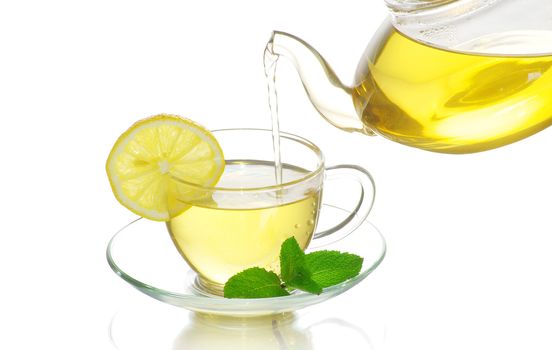 tea being poured into glass tea cup
