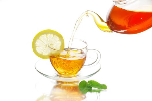 tea being poured into glass tea cup