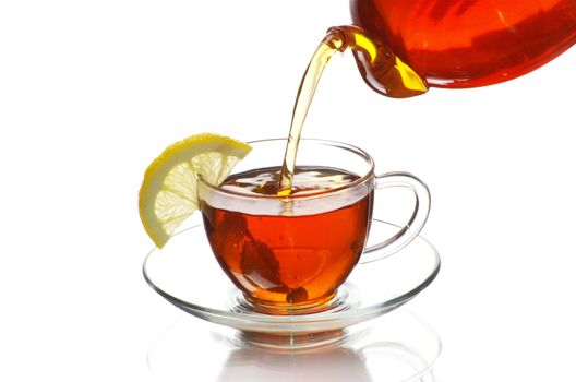tea being poured into glass tea cup