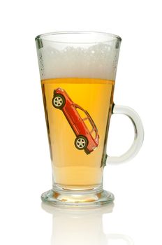 Small vehicle inside a glass of beer