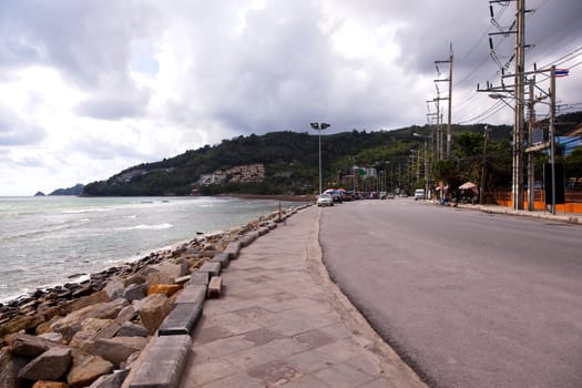 The road from Patong to Phuket. Against the background of the cloudy sky. Editorial only.