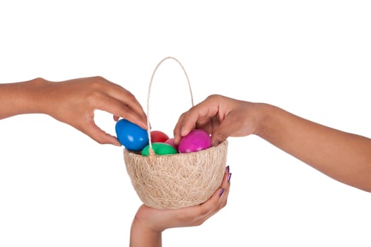 Hand holding colorful Easter eggs in the basket