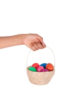 Hand holding colorful Easter eggs in the basket