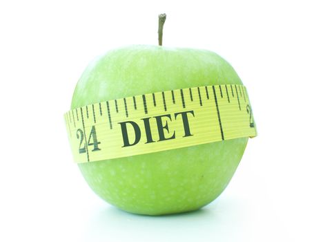 Tape measure labelled with the word diet wrapped around a healthy green apple
