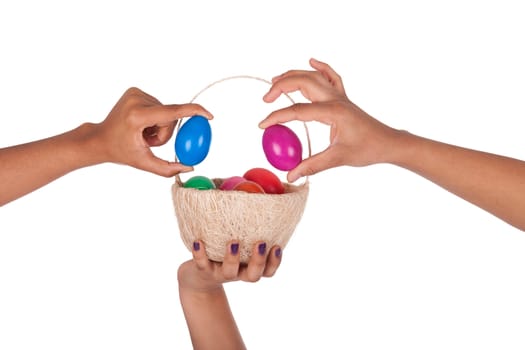 Hand holding colorful Easter eggs in the basket