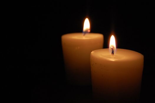 Two candles glowing in the dark (also space for text)