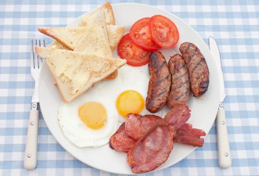 Delicious english breakfast fry up with sausages, eggs and bacon