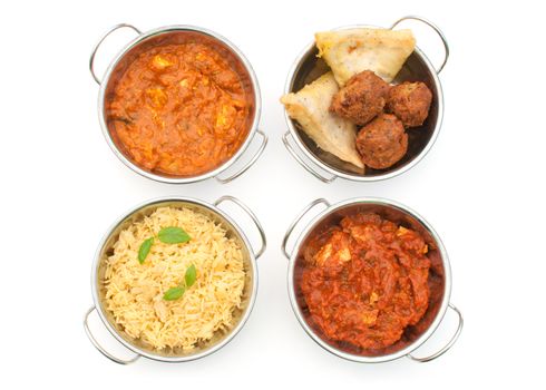 Curry dishes including chicken jalfrezi, tikka masala and samosas over a white background