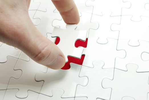 hands holding a puzzle piece . business concepts
