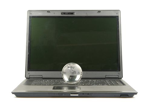 glass globe placed on a laptop isolated on white