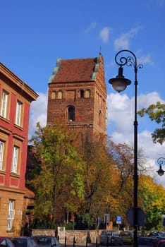 Old Town in Warsaw. Medieval church on the end of street.