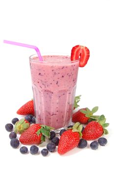Berry smoothie milkshake surrounded by fruit