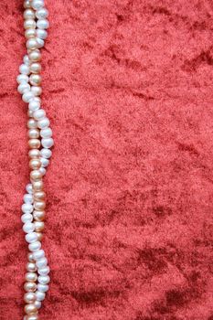 White and pink pearls on the terracotta velvet can use as background