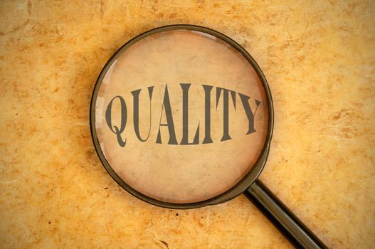 Magnifying glass focused on the word quality 