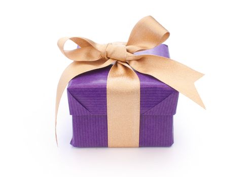 Purple wrappe gift box with a gold ribbon 