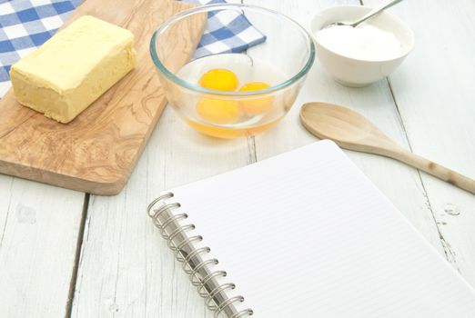 Blank recipe book surrounded with ingredients