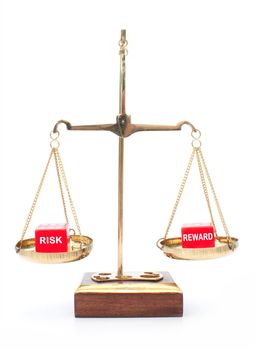 Risk and reward dice on weighing scales 