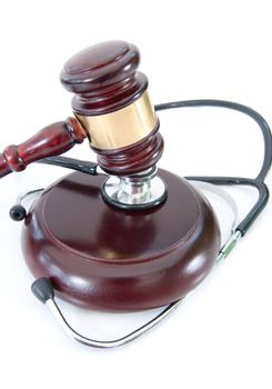 Stethoscope wrapped around a gavel over a white background