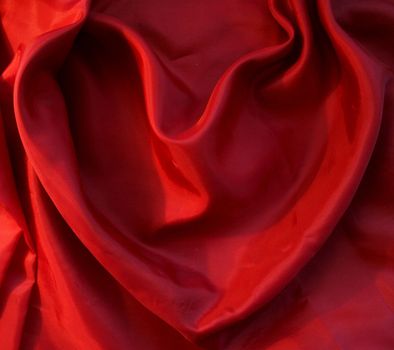 Red heart from elegant red silk for St Valentine's day background

