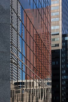 reflected in a glass wall of a high-rise building