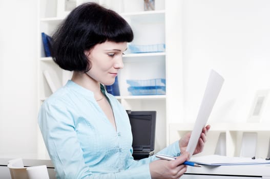 Portrait of a business woman in the office doing some paperwork