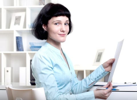 Portrait of a business woman in the office doing some paperwork