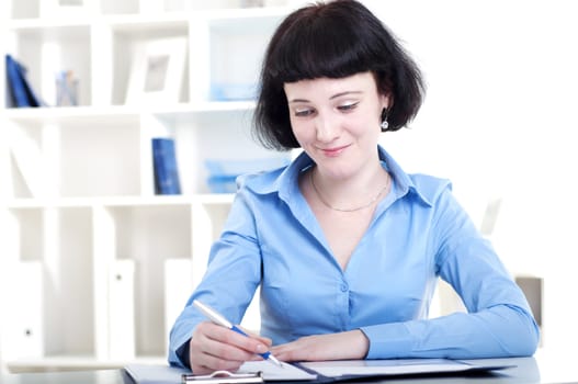 Portrait of a business woman in the office doing some paperwork