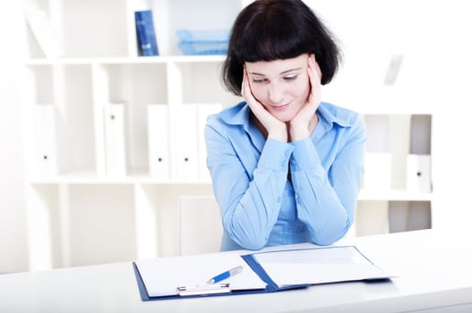 Portrait of a business woman in the office doing some paperwork