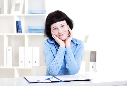 Portrait of a business woman in the office doing some paperwork