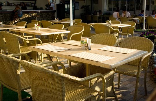 Wicker chairs in a open-air cafe