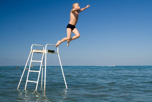 Boy jumping in the water